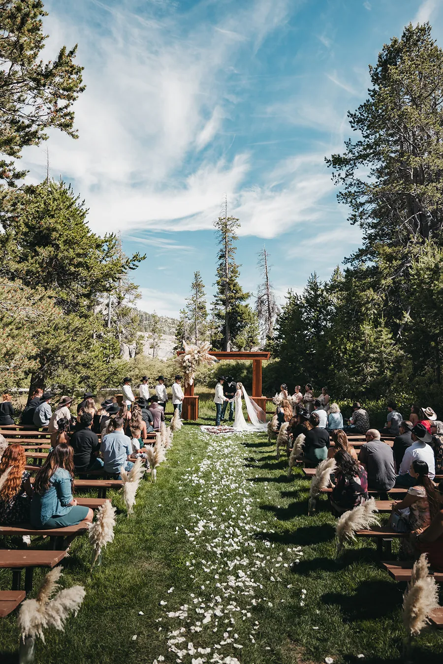 The recessional back down a petal aisle lined with log benches.