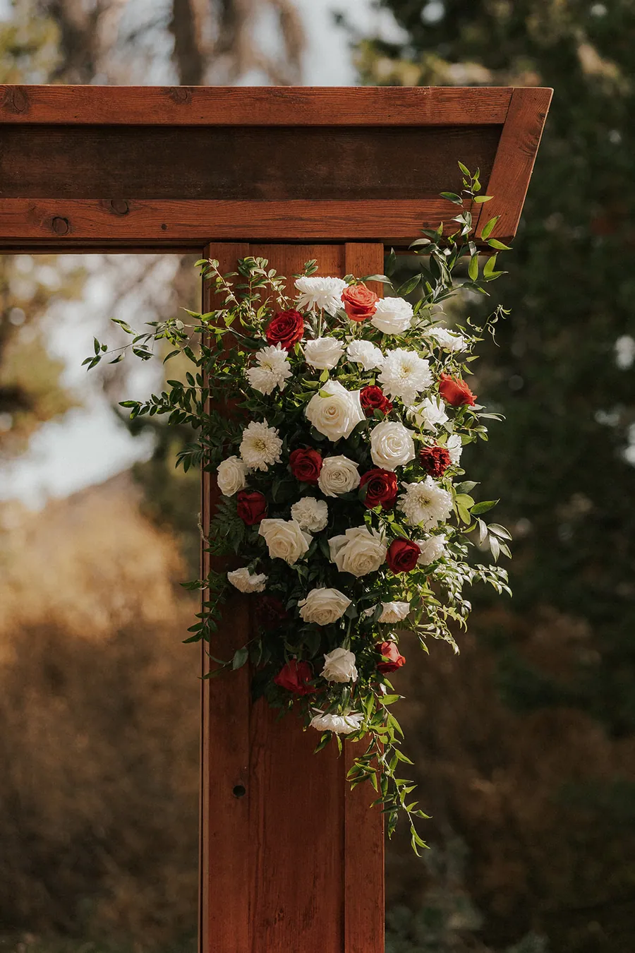 Roses and greenery on the timber arbor post.